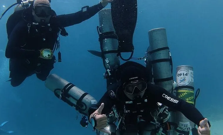 Sidemount technical diver over a Red Sea reef