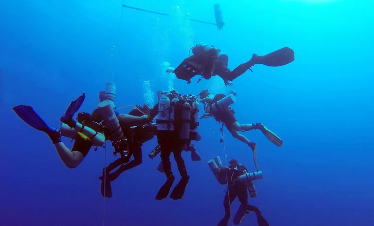 Technical team descending into the deep blue of the Red Sea