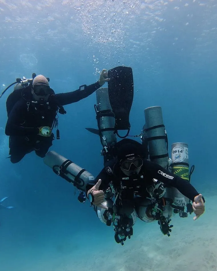 Sidemount technical diver over a Red Sea reef